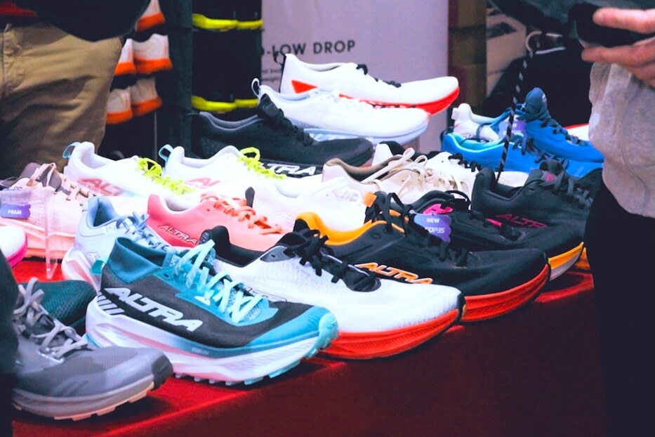Running shoes arranged on a display table at the expo, photo by The Foot Collective